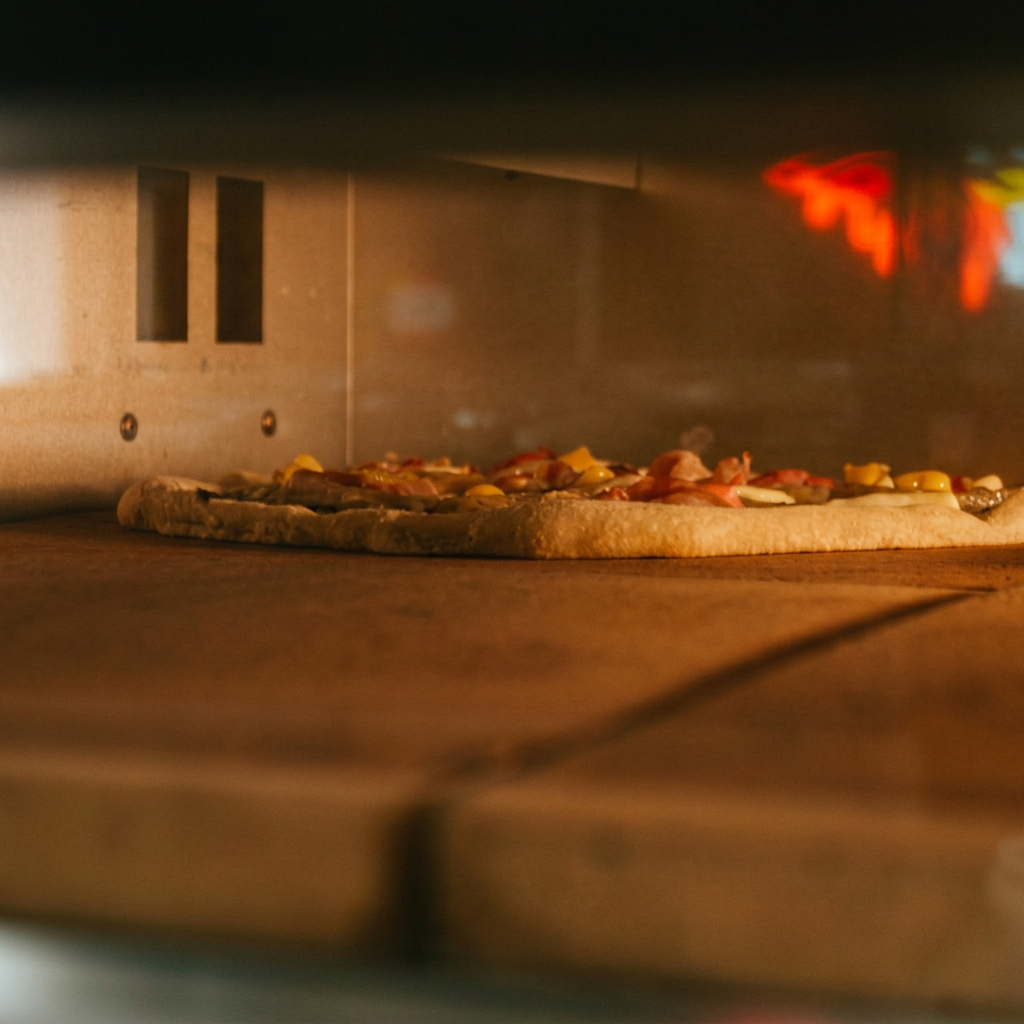 Pizza baking on the oven stone